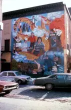 cars parked in front of the chinatown mural 